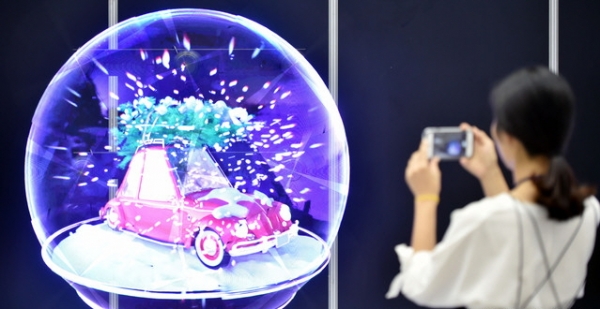 13일 대구 북구 산격동 엑스코에서 열린 ‘2018 대한민국 ICT융합엑스포’를 찾은 관람객이 LED를 이용한 3D 홀로그램 디스플레이를 살펴보고 있다.