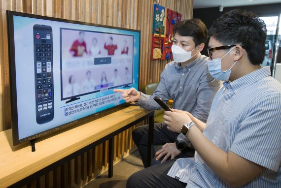 삼성전자 상품전략팀 직원(왼쪽)이 서울 관악구에 위치한 실로암 시각장애인 복지관에서 한 시각장애인에게 삼성전자 스마트TV의 접근성 기능에 대해 설명하고 있다. 삼성전자 제공