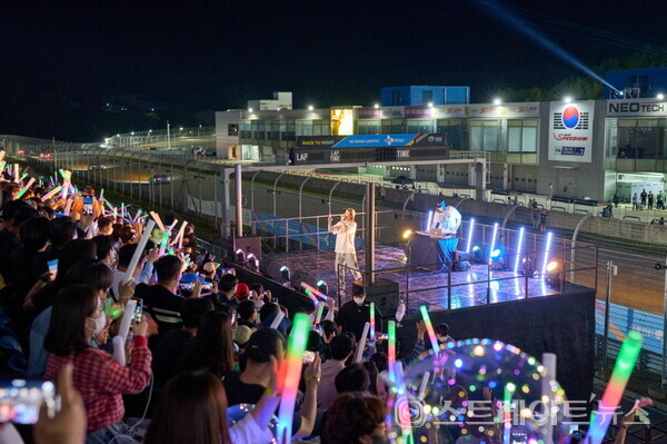 ▲가수 넉살의 축하공연을 보며 열띤 호응을 보내는 관중들(2022 CJ대한통운 슈퍼레이스 챔피언십 3라운드 나이트 레이스) / 사진=슈퍼레이스