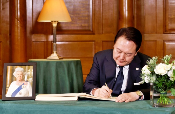 윤석열 대통령이 19일 영국 런던 웨스트민스터 사원에서 엄수된 엘리자베스 2세 여왕 장례식에 참석한 뒤 조문록을 작성하고 있다.(사진=연합뉴스)