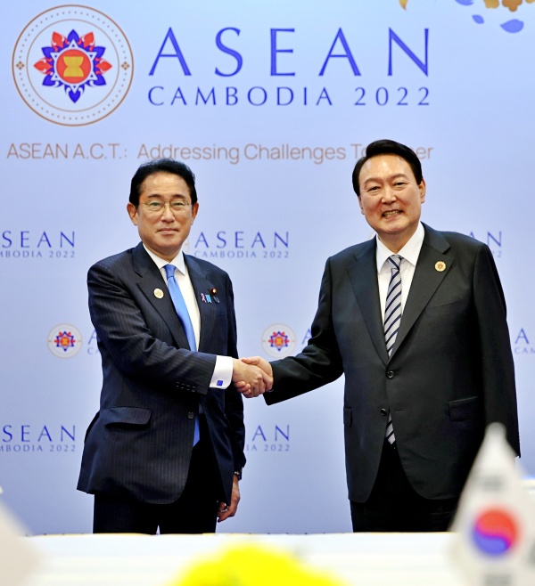 윤석열 대통령이 13일(현지시간) 캄보디아 프놈펜 한 호텔에서 열린 한일 정상회담에서 기시다 후미오 일본 총리와 악수하며 기념촬영을 하고 있다./사진=연합뉴스