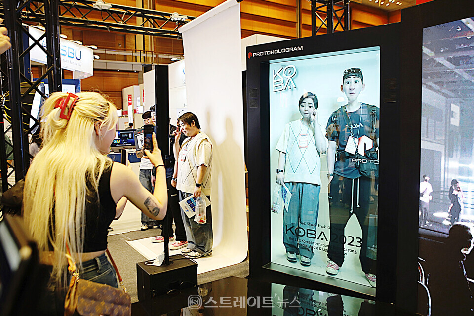 ▲지난 19일 제31회 국제 방송⋅미디어⋅음향⋅조명전시회(KOBA 2023)에서 관람객들이 프로토 홀로그램(PROTO Hologram)을 직접 체험하고 있다. / 양용은 기자 taeji1368@naver.com