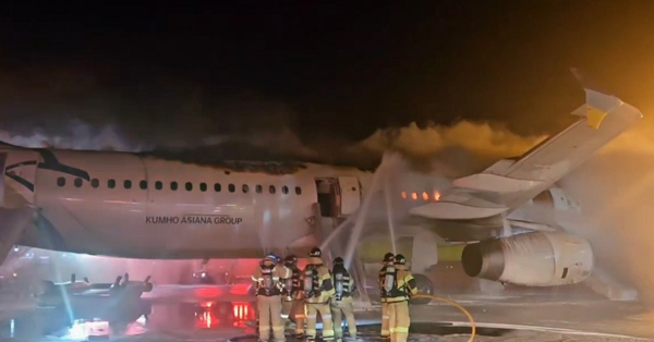 28일 밤 김해공항에서 화재로 검게 타오르는 에어부산 비행기. 연합뉴스 제공.