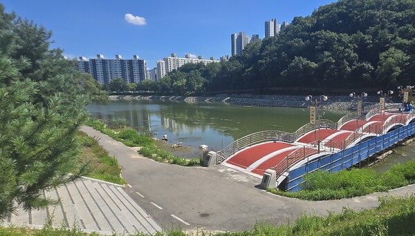 단지 북단을 흐르는 공지천과 수변공원. 수변공원 너머 야산 뒤편 오르쪽의 단지는 ‘1차 아이파크’ 건설현장이고, 사진 왼편으로 ‘온의금호1차아파트’와 ‘온의보배아파트’가 보인다. 김태현 기자
